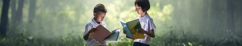 children reading outdoors